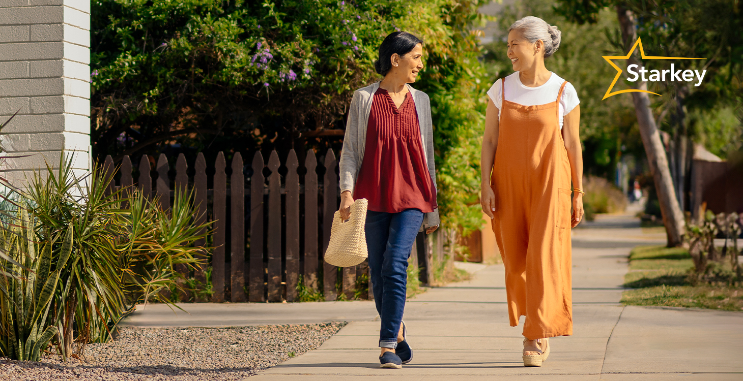 Image of two women walking down the sidewalk chatting